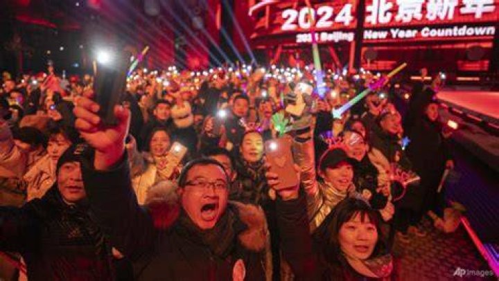 Revellers cheer before a countdown to the new year in Beijing.